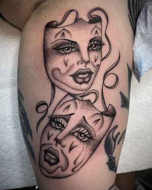 Unique blackwork upper arm tattoo of a mysterious woman's face partially covered by a mask, expertly done by Sasha Ignarski.