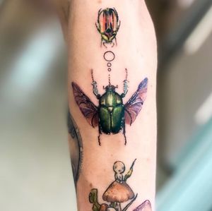 Experience stunning realism with this illustrative beetle tattoo on your arm by the talented artist, Juliany Braga.
