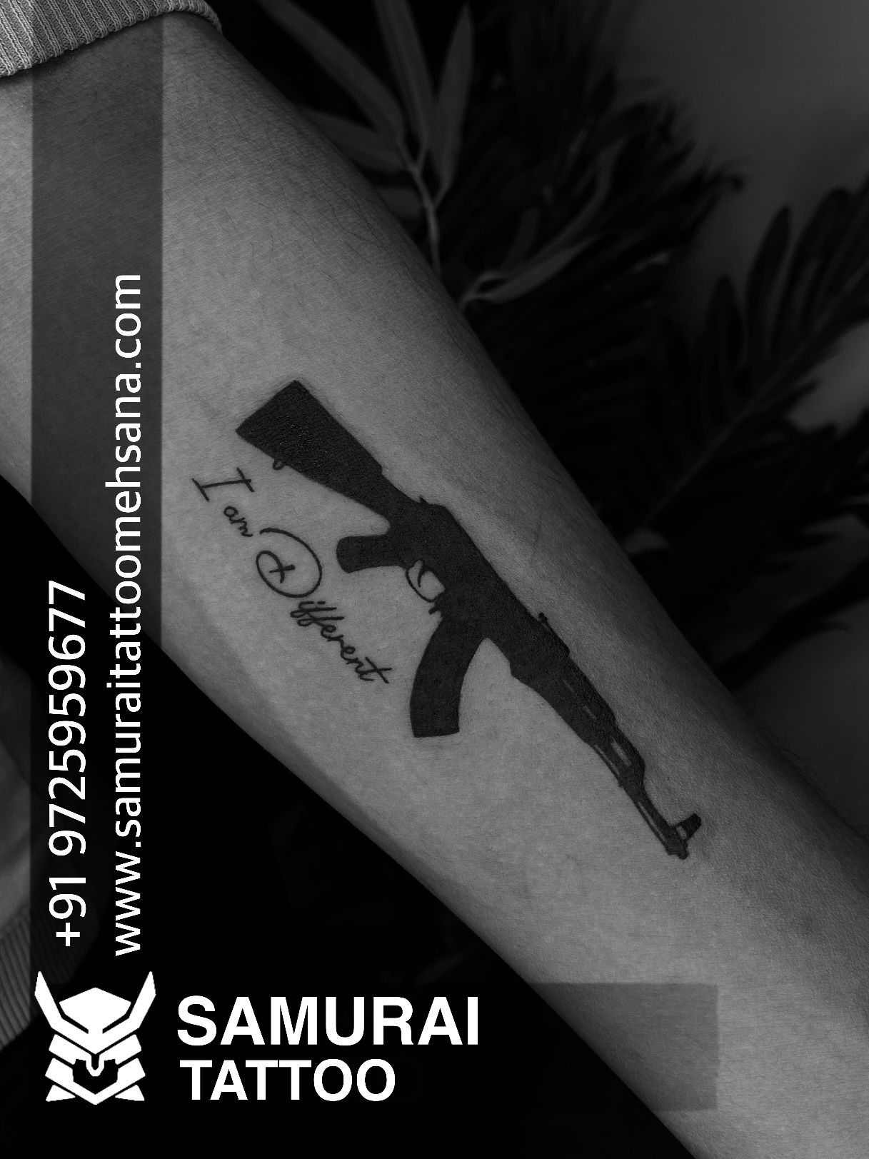 Download Man With Gun Tattoo Arm Picture | Wallpapers.com