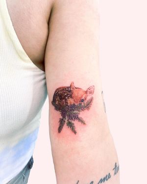 Beautiful upper arm tattoo by Juliany Braga featuring a majestic deer and delicate flower design. Perfect for nature lovers.