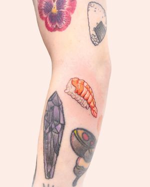 Get a mouthwatering illustrative sushi tattoo on your arm by Juliany Braga. Perfect for foodies and sushi lovers!