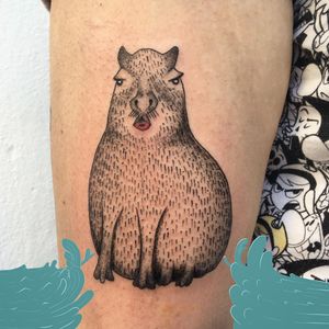 Illustrative blackwork tattoo of a cute capybara, beautifully done on the upper arm by talented artist Maritana Quaresma.