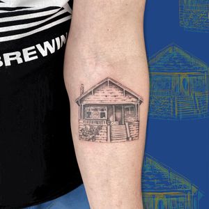 Get mesmerized by Maritana Quaresma's illustrative house tattoo on your forearm. A unique blend of mystery and artistry.