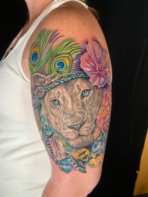 Lioness with florals and peacock feathers