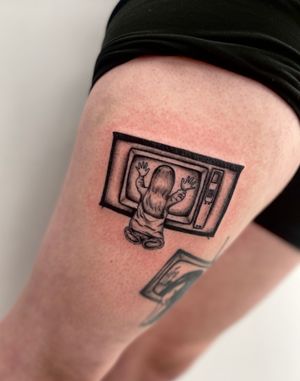 Blackwork and illustrative style upper leg tattoo of a girl from Poltergeist movie, by Miss Vampira.