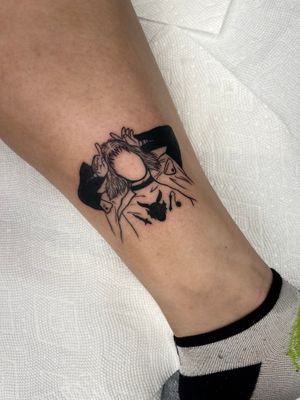 Fine-line blackwork ankle tattoo featuring a devilish man holding a sword, inspired by Eddie. Perfect for dark and edgy vibes.