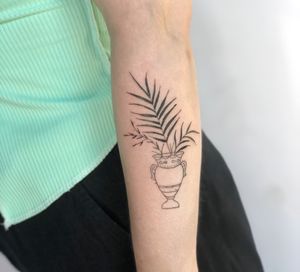 Vase and palm leaf