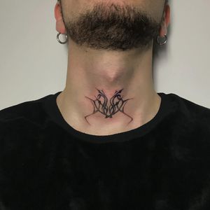 Get a bold and sophisticated patterned tattoo on your neck by the talented artist Amour.x. Perfect for those wanting a unique statement piece.
