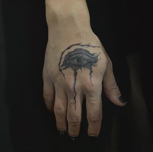 Get mesmerized with this unique blackwork eye tattoo on your hand by Amour.x. Experience timeless beauty and symbolism.