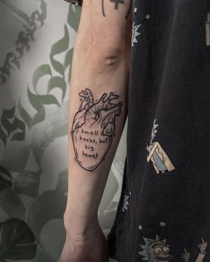Express your love with Emiliia Kuzmina's blackwork heart and quote design on your forearm.