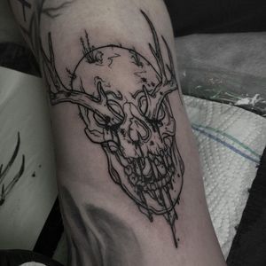 Emiliia Kuzmina's illustrative blackwork tattoo featuring a skull with horns, perfect for arm placement.