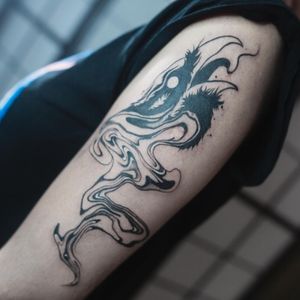 Explore the detailed and unique blackwork pattern on your upper arm, crafted by the talented artist Greed.