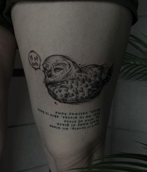 Emiliia Kuzmina's upper leg tattoo features a stunning blackwork owl and intricate lettering of a meaningful quote.