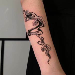 Unique pattern tattoo by Greed, perfectly blending blackwork style with detailed illustrations on the forearm.