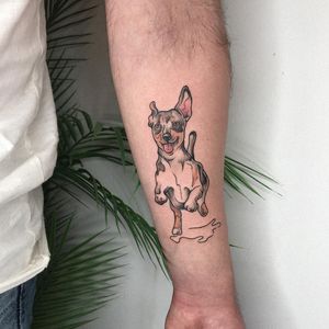 Express your love for dogs with this stunning illustrative tattoo on your forearm by talented artist Emiliia Kuzmina.