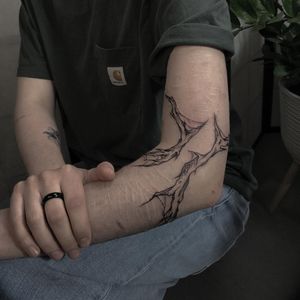 Elegant blackwork pattern tattoo on the arm, created by the talented artist Emiliia Kuzmina. A stunning and unique illustrative design.