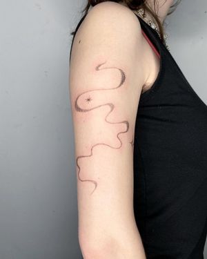 Elegant dotwork pattern design on upper arm by talented artist Silber/Sofie. Perfect for those seeking unique and stylish body art.