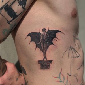 Illustrative blackwork tattoo featuring a devil woman with wings on the ribs by Amour.x