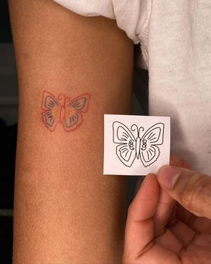Get a beautiful butterfly tattoo done in the illustrative style by Silber/Sofie on your upper arm. Experience fine line art at its best!
