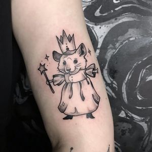 Unique blackwork forearm tattoo featuring a rat, star, and crown, beautifully designed by Emiliia Kuzmina.