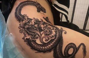 “Body of a dragon w/ the head of a snake. Addition of florals and butterfly“ My first and personal favorite to this day ! by James @ Twisted Tattoo 