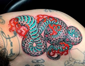 Experience the power and beauty of a Japanese snake motif tattoo by the talented Matthew Ono. Embrace the traditional art form with a modern twist.