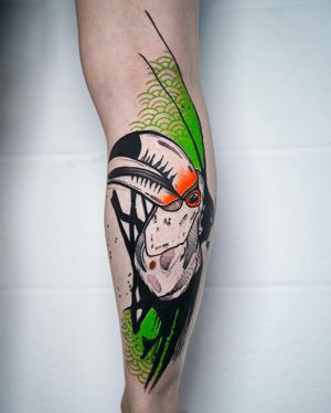 Capture the vibrant beauty of a toucan and intricate patterns on your lower leg with this blackwork tattoo by Joza.