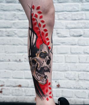 Unique blackwork and illustrative design by Joza featuring a skull and intricate pattern on the lower leg.