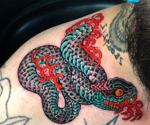 Experience the artistry of Matthew Ono with this intricate Japanese snake design on your shoulder.