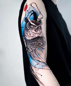 Unique blackwork design by Joza, featuring a majestic owl with intricate patterns on upper arm.