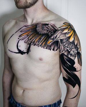 Impressive blackwork eagle design with intricate patterns on chest by Joza.
