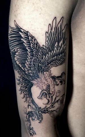 Elegant black and gray traditional eagle tattoo on upper leg by Matthew Ono.