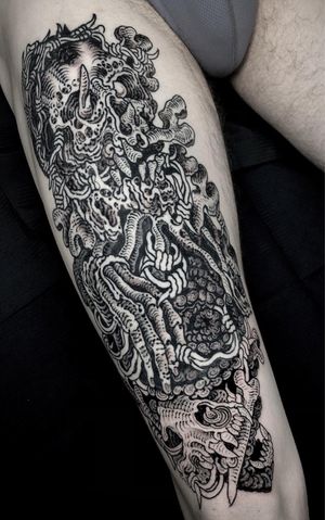 Black and gray upper leg tattoo featuring a skull, skeleton, and teeth, done by Matthew Ono in blackwork style.