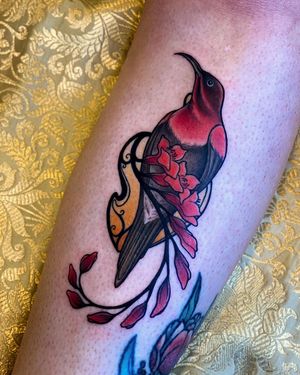 Beautiful neo-traditional tattoo of a bird and flower on the arm, skillfully done by Edyta.