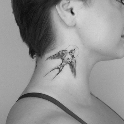 Beautiful illustrative bird tattoo on neck by artist Oscar Jesus. Detailed fine line work.