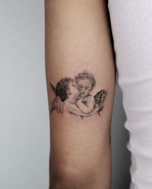 Stunning blackwork angel tattoo by Oscar Jesus, blending realism and illustrative style. Adorn your arm with divine cherub.