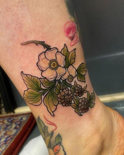 Vibrant neo traditional tattoo on the lower leg, featuring a beautiful combination of flowers and fruits, by artist Edyta.
