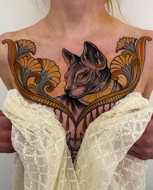Elegant neo traditional design by Edyta featuring a cat surrounded by intricate filigree on the chest.