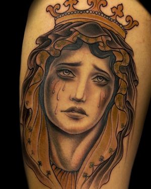 Embrace the beauty of Chicano and neo-traditional styles with this stunning arm tattoo featuring a crown, a woman, and tears. Inked by Edyta.