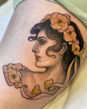 Beautiful tattoo of a woman intertwined with colorful flowers on the arm. Expertly done by Edyta in a neo-traditional style.