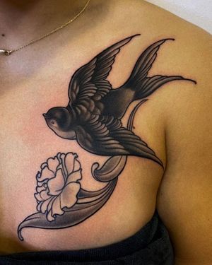 Get a stunning neo-traditional chest tattoo of a bird and flower by the talented artist Edyta. Perfect blend of traditional and modern styles.