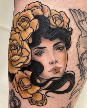 Get a stunning neo-traditional arm tattoo featuring a beautiful woman and intricate flower design by the talented artist, Edyta.