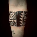 Explore the ancient beauty of blackwork tribal patterns with this stunning forearm tattoo by David Barclay ओं.