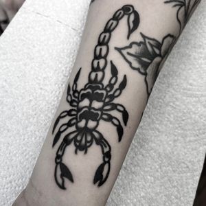 Get inked with a fierce scorpion design by tattoo artist Alessandro Lanzafame. Bold and timeless traditional style.