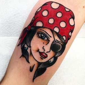A bold and classic forearm tattoo featuring a traditional depiction of a pirate woman by the talented artist Alessandro Lanzafame.
