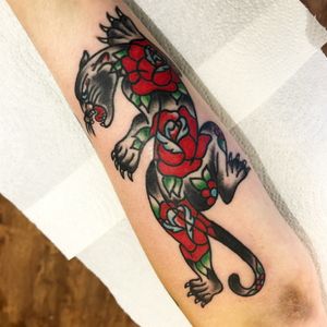 Get inked with a fierce panther surrounded by delicate flowers, expertly done by Alessandro Lanzafame.