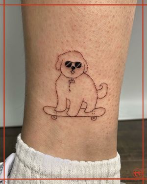 Get a unique and playful tattoo on your ankle by Tianna, featuring a dog on a skateboard in fine line style.
