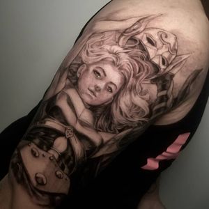 Inkcognito's striking blackwork upper arm tattoo featuring a beautiful girl wearing a mask and armor.