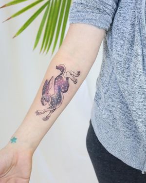 Elegant forearm tattoo of a rabbit in a detailed illustrative style, executed by the talented artist Cerf.