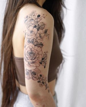 Get a stunning tattoo of a flower on your arm by the talented artist Sasha Sunshine. Perfect combination of blackwork and illustrative style.